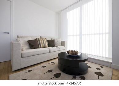 Detail of a modern living area with beige sofa and stylish coffee table with decorations