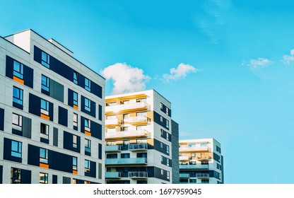 Detail in Modern residential flat apartment building exterior. Fragment of New luxury house and home complex. Part of City Real estate property and condo architecture. Copy space. Blue sky