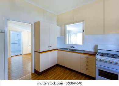 Detail Of A Modest Kitchen With A Gas Stove Connected To Another Room