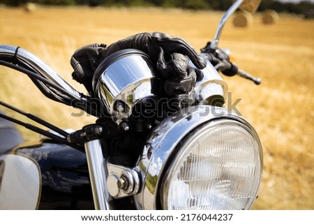 Similar – Couple sitting over motorcycle ready to go