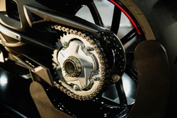 Detail Of A Motorcycle Rear Chain With Exhaust Pipes. Rear View Of A Motorcycle With The Focus On Chain.