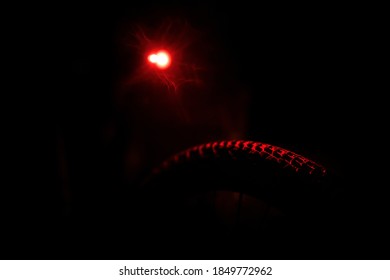 Detail Of A Mountain Bike Tire Illuminated By A Rear Light.