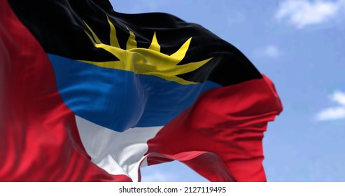 Detail of the national flag of Antigua and Barbuda waving in the wind on a clear day. Antigua and Barbuda is a sovereign island country in the West Indies in the Americas. Selective focus.