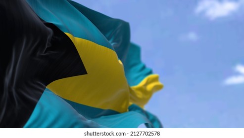 Detail of the national flag of the Bahamas waving in the wind on a clear day. Bahamas is a sovereign country within the Lucayan Archipelago of the West Indies in the Atlantic. Selective focus.
