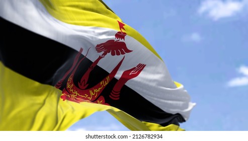 Detail Of The National Flag Of Brunei Waving In The Wind On A Clear Day. Democracy And Politics. Patriotism. Selective Focus. South East Asian Country.
