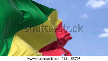 Detail of the national flag of Congo Republic waving in the wind on a clear day. Congo Republic is a country located in the western coast of Central Africa. Selective focus.