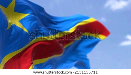 Detail of the national flag of the Democratic Republic of the Congo waving in the wind on a clear day. The DRC is a country in Central Africa. Selective focus.