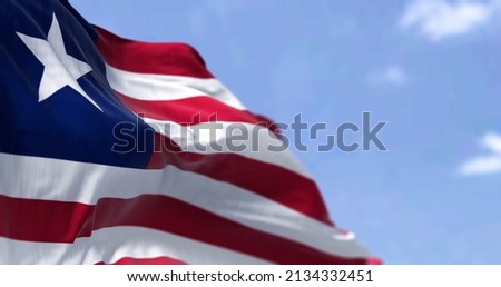 Detail of the national flag of Liberia waving in the wind on a clear day. Liberia is a country on the West African coast. Selective focus.