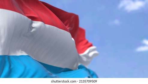 Detail of the national flag of Luxembourg waving in the wind on a clear day. Luxembourg is a landlocked country in Western Europe. Selective focus.