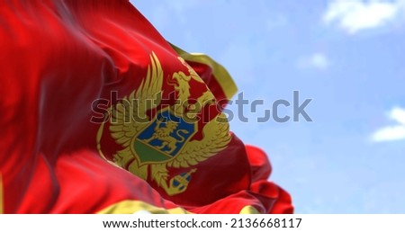 Detail of the national flag of Montenegro waving in the wind on a clear day. Montenegro is a country in Southeastern Europe. Selective focus.