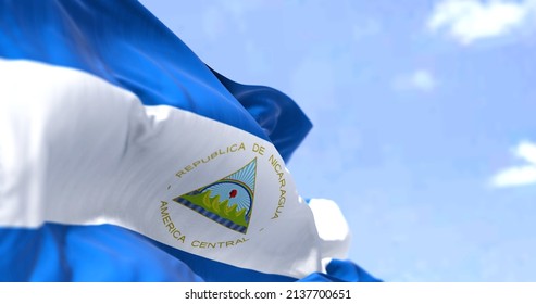 Detail of the national flag of Nicaragua waving in the wind on a clear day. Nicaragua is the largest country in the Central American isthmus. Selective focus.