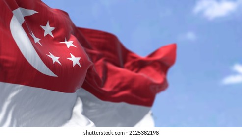 Detail Of The National Flag Of Singapore Waving In The Wind On A Clear Day. Democracy And Politics. Patriotism. South East Asian Country. Selective Focus.