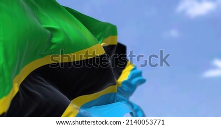 Detail of the national flag of Tanzania waving in the wind on a clear day. Tanzania is a country in East Africa. Selective focus.