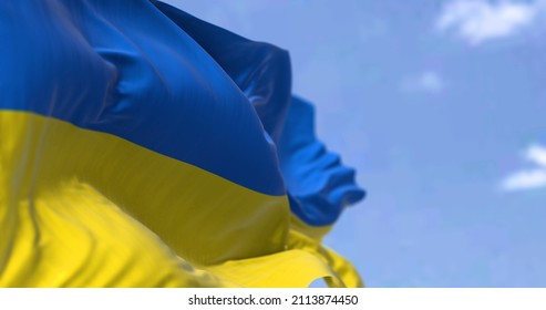 Detail of the national flag of Ukraine waving in the wind on a clear day. Democracy and politics. Eastern Europe country. Patriotism. Selective focus. - Shutterstock ID 2113874450
