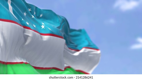 Detail of the national flag of Uzbekistan waving in the wind on a clear day. Uzbekistan is a landlocked country in Central Asia. Selective focus.