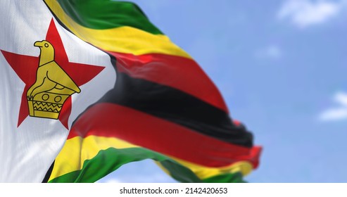 Detail of the national flag of Zimbabwe waving in the wind on a clear day. Zimbabwe is a landlocked country located in Southeast Africa. Selective focus.