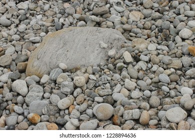 Detail Of Natural Stones, Smaller Stones Surrounding A Larger Flat Rock Face, On A Hebrides Island Beach, South Uist, Scotland.