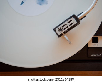 Detail of a needle on a track of a white vinyl record. Vintage turntable. - Shutterstock ID 2311314189