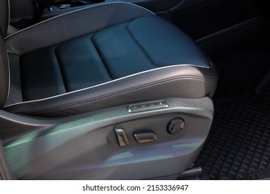 Detail of new modern car interior, Focus on seat adjust switch. The front passenger seat of a luxury business class car. Car seat manual adjust stick panel to control seat position in passenger car.