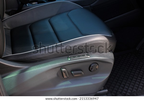 Detail of new modern car interior, Focus on seat\
adjust switch. The front passenger seat of a luxury business class\
car. Car seat manual adjust stick panel to control seat position in\
passenger car.