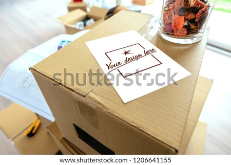 Detail of note over stack of moving boxes. Customizable note design