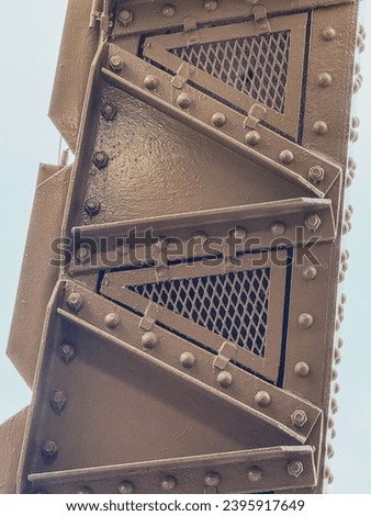 Detail of the nuts, rivets and plates that form one of the beams of the Eiffel Tower in Paris, France.