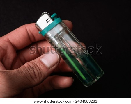detail of object a green plastic lighter, green gas lighter concept