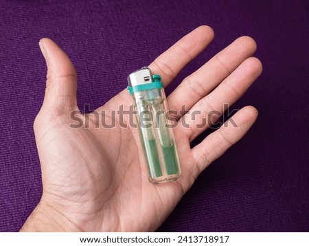 detail of object a green plastic lighter, green gas lighter concept