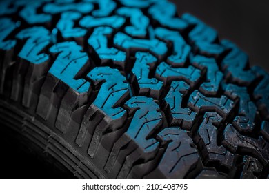 Detail Of Off Road Or Offroad 4x4 Tire Tread. Studio Lighting With Strong Blue Backlight Of An Automotive Tire Tread.
