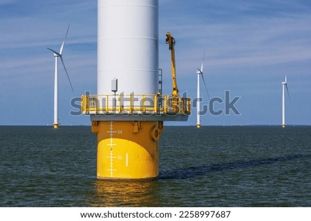 Detail of an offshore wind turbine with monopile foundation and maintenance platform and lower part of the tower in the Windpark Noordoostpolder on the IJsselmeer in the Netherlands, Flevoland