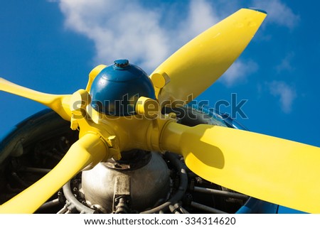 Detail of an old airplane's yellow propeller