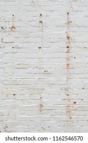 Detail Of Old Brick Wall Painted White And Distressed, Peeling And Stained. Ideal For Grunge Background Texture