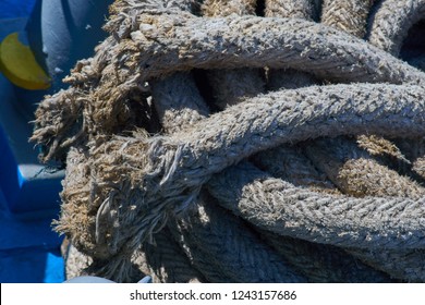Detail Of An Old Frazzled Ship Mooring Rope Rolled Up On The Deck Of A Ferry Boat.