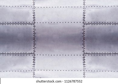 detail of old grunge piece of metal plate with bolts, aluminum surface background