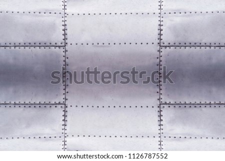 detail of old grunge piece of metal plate with bolts, aluminum surface background