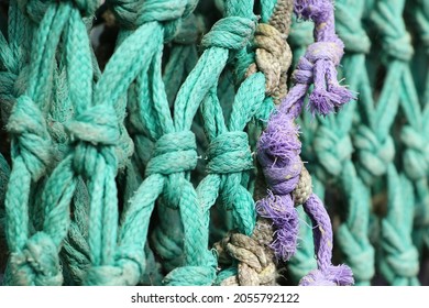 Detail Of Old Knotted Fishing Net Of Aqua Colored Nylon Rope 