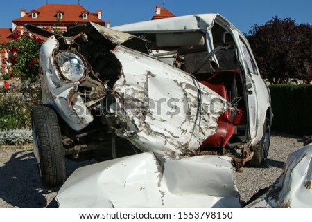 The detail of an old veteran small car after the collision with a modern car during the traffic accident. The car is destroyed completely. Shows the low level of passive safety. 