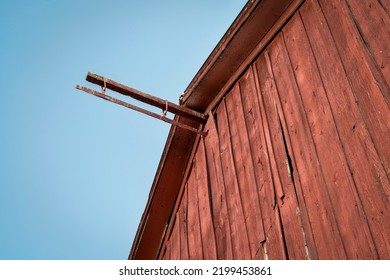 detail of old, weathered, red barn against dusk sky at Colorado foothills