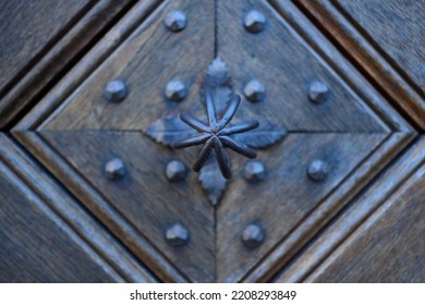 Detail Of An Old Wooden Door With Traditional Metal Door Knob.