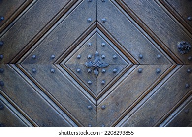 Detail Of An Old Wooden Door With Traditional Metal Door Knob.