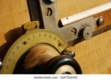 Detail of old wooden drawing board with measurement and rulers, angle and tilt metal mechanism
