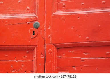 Detail Of Old Wooden Red Painted Door With Heart Shaped Key Hole