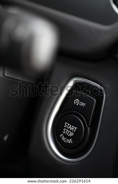 Detail on a black start\
button in a car.