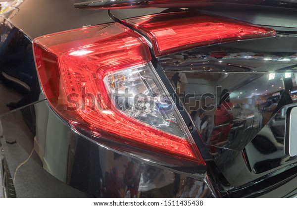 Detail on the rear\
light of a black.  black sport hybrid car rear light parts. Tail\
light of luxury sport\
car
