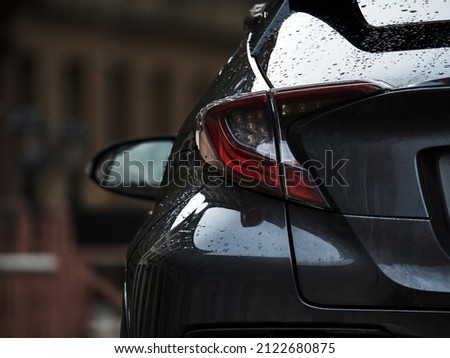 Detail on the rear light of a car. Grey car rear light close up