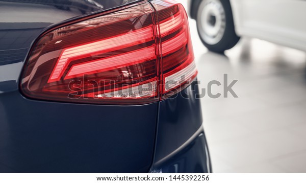 Detail on the rear\
light of a car. Car detail. Developed Car\'s rear brake light. The\
car is in the showroom