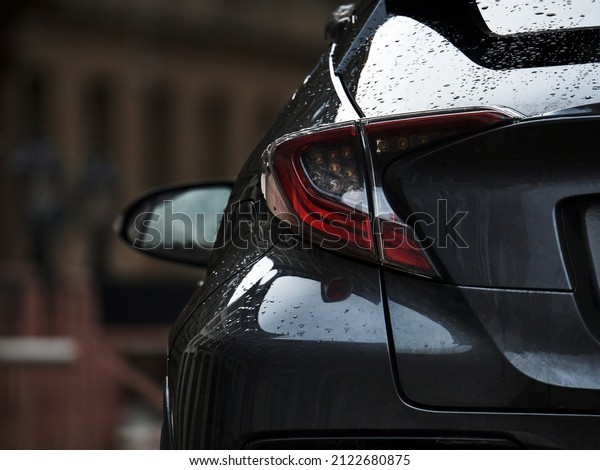 Detail on the rear light of a car. Grey car rear light\
close up