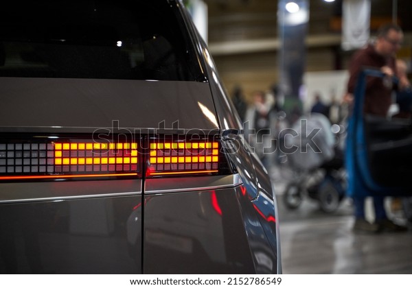 Detail on the rear light of a car. Car\
detail. Developed Car\'s rear brake light. Silver\
car.