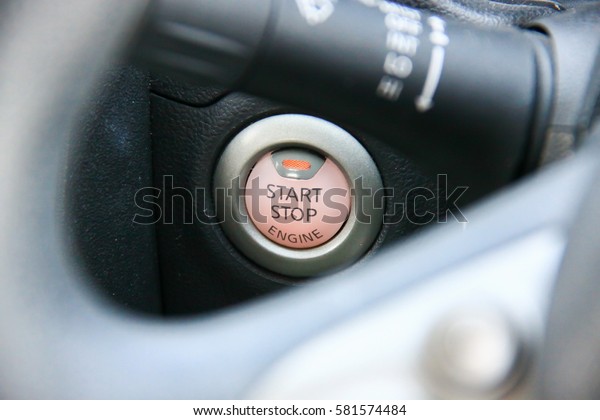 Detail on the start button\
in a car
