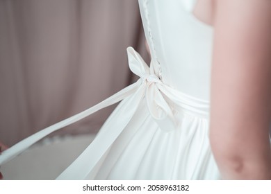 Detail on wedding dress, bride
